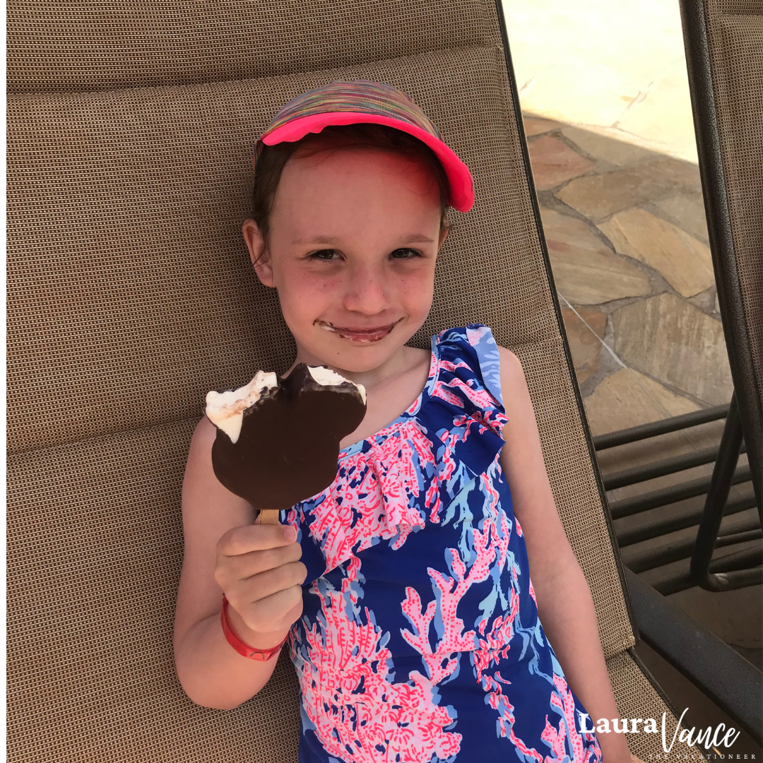 girl eating a Mickey bar at Aulani in Hawaii