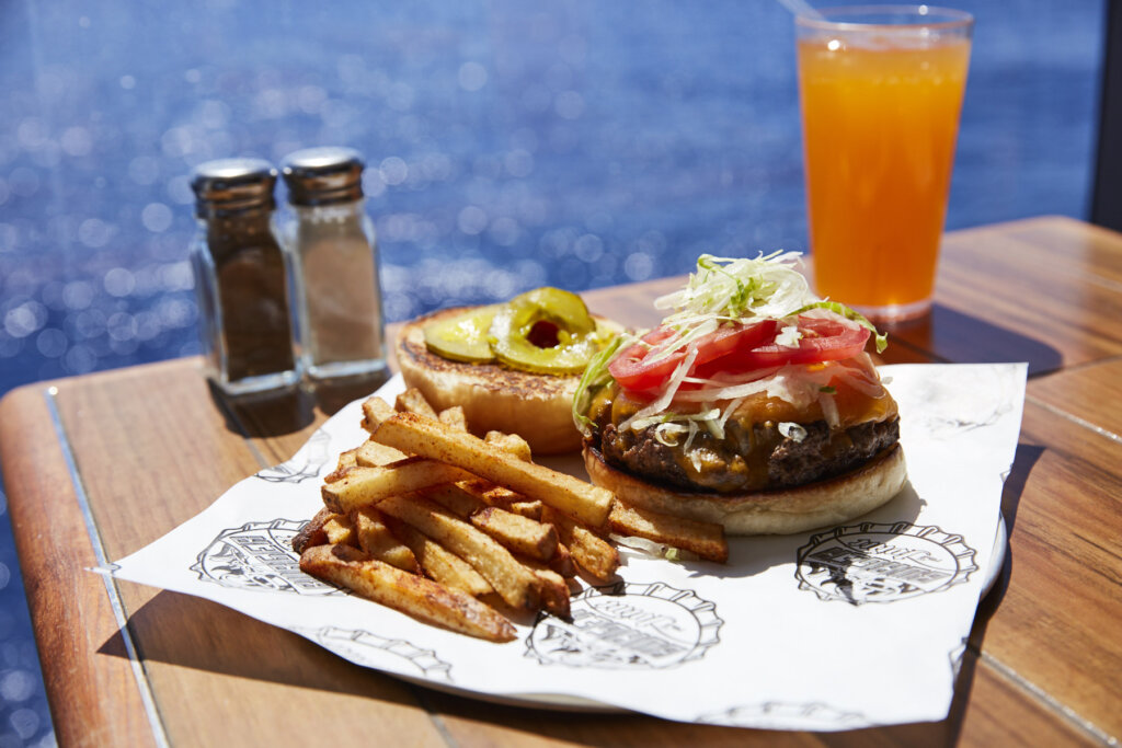 guy's burger and fries with ocean in background